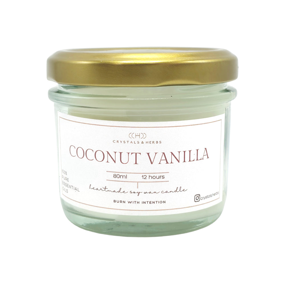Coconut vanilla candle in a glass jar with a gold lid 